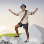 student exploring the top of a mountain