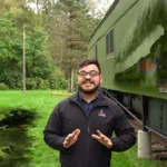 An instructor next to a train.