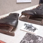 Antique ice skates on display in a museum.