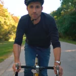 A man riding a bicycle on a path.